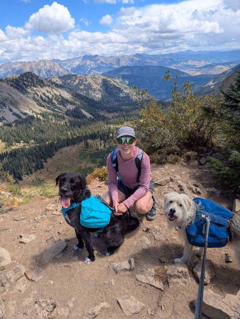 Mitchell’s wife hiking in the mountains with their two dogs.