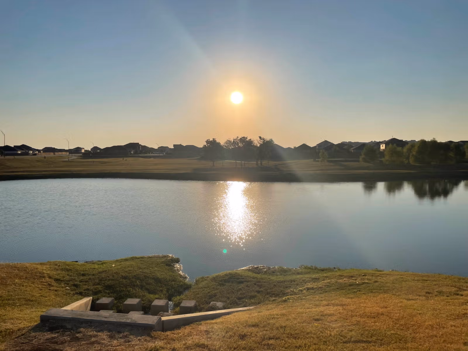 Sunrise over a lake during Alan's Function story feature.