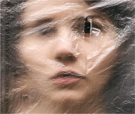 Person holding plastic packaging in the environmental toxins article.